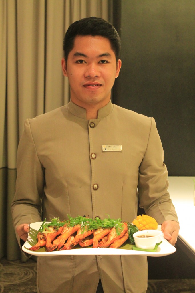 Victor of F&B Service offering grilled prawns